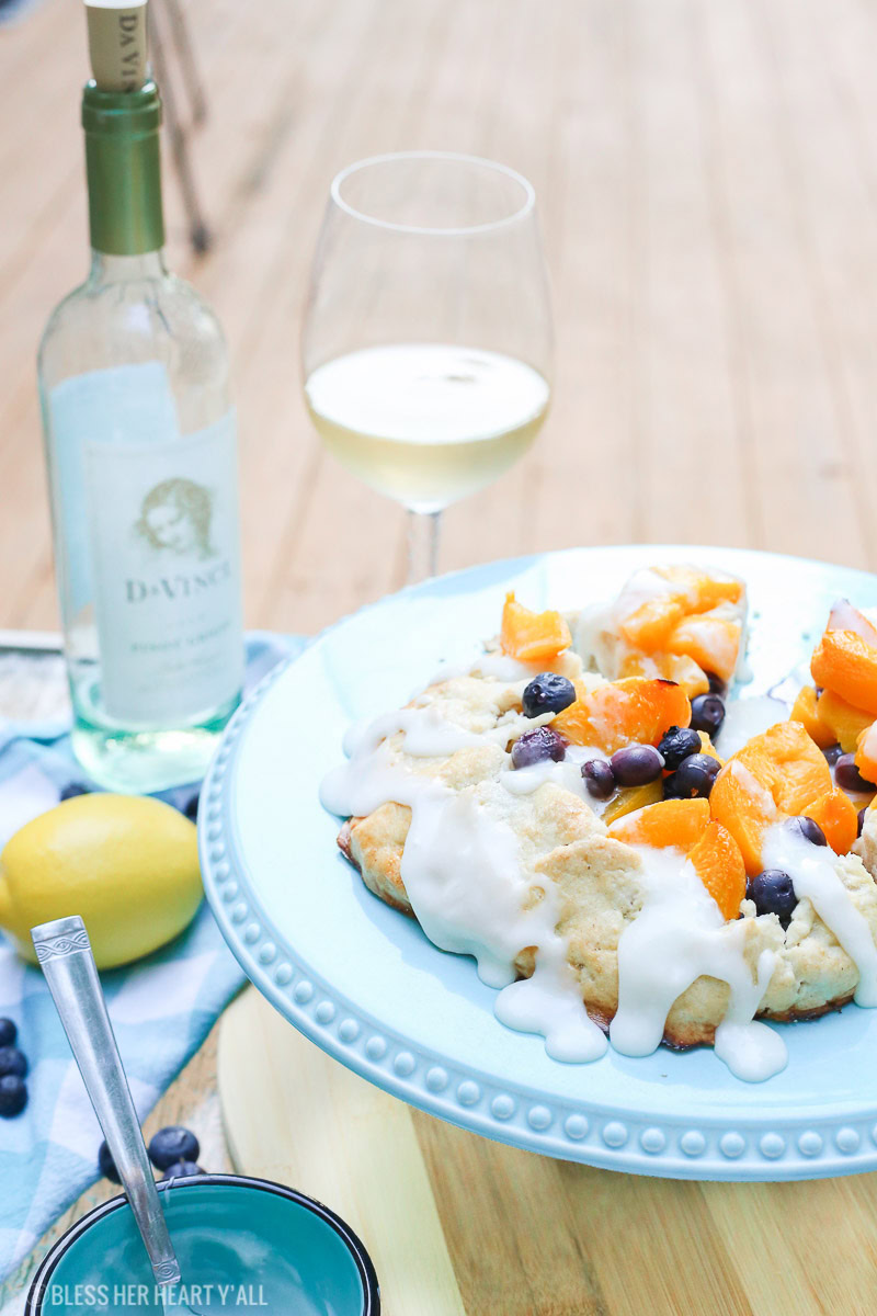 This peach blueberry galette combines peach slices and fresh blueberries in a sweet juicy sauce and then spreads it inside a doughy sugar-lined crust and bakes it all to golden perfection. This gluten free tart is drizzled in a light lemon glaze and is the perfect summer snack to enjoy outside on the back deck with a chilled bottle of white wine!