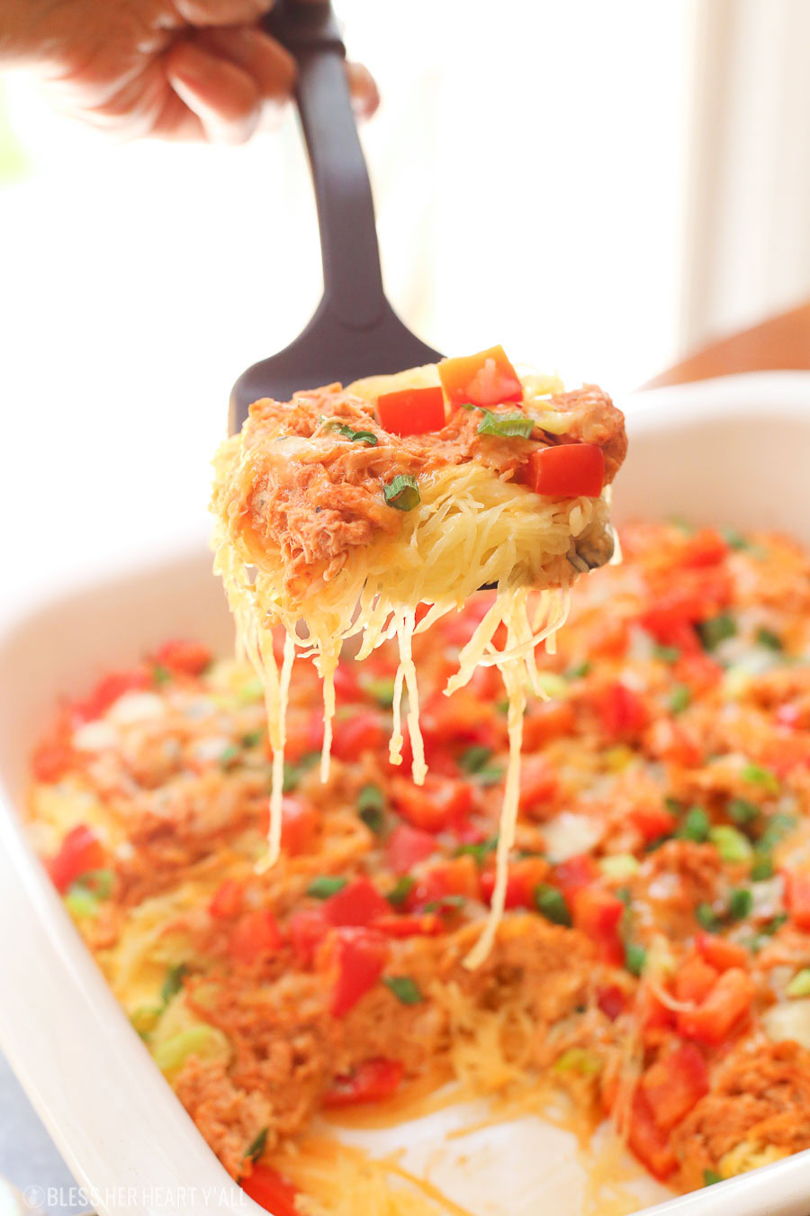 Skinny buffalo chicken spaghetti squash bake combines creamy flavor-packed buffalo chicken with fresh veggies and blue cheese crumbles all on a bed of spaghetti squash!