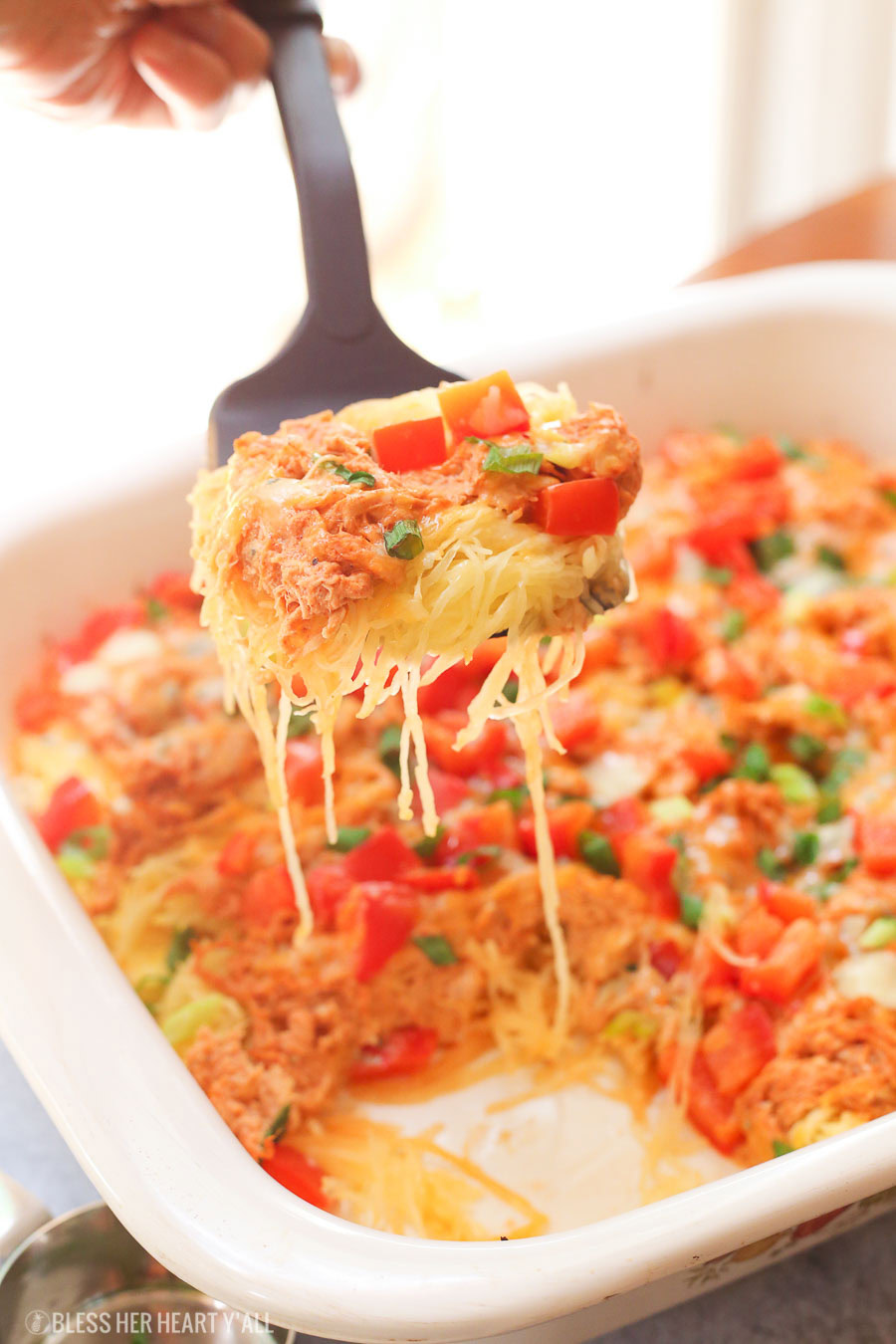 Skinny buffalo chicken spaghetti squash bake combines creamy flavor-packed buffalo chicken with fresh veggies and blue cheese crumbles all on a bed of spaghetti squash!