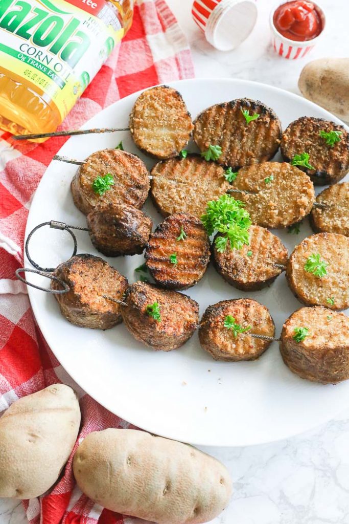 Grilled Marinated Potatoes on Skewers served on a plate