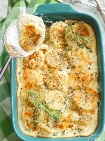 overhead shot of scalloped potatoes in dish and in serving spoon