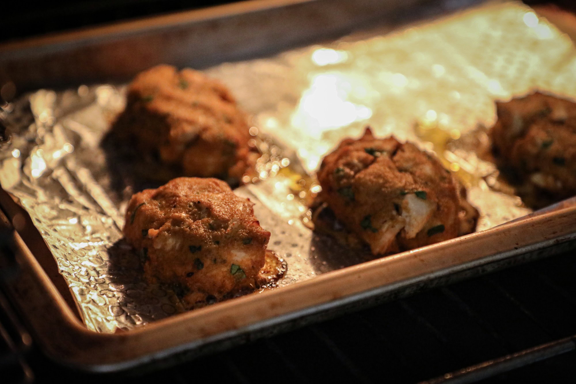 4 crab balls cooking in the oven