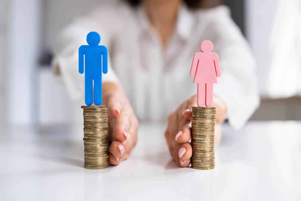 Man and Woman standing on coins, being pushed apart