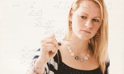 A woman writing algebraic equations