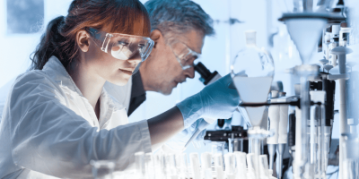 A medical laboratory assistant working with a lab tech