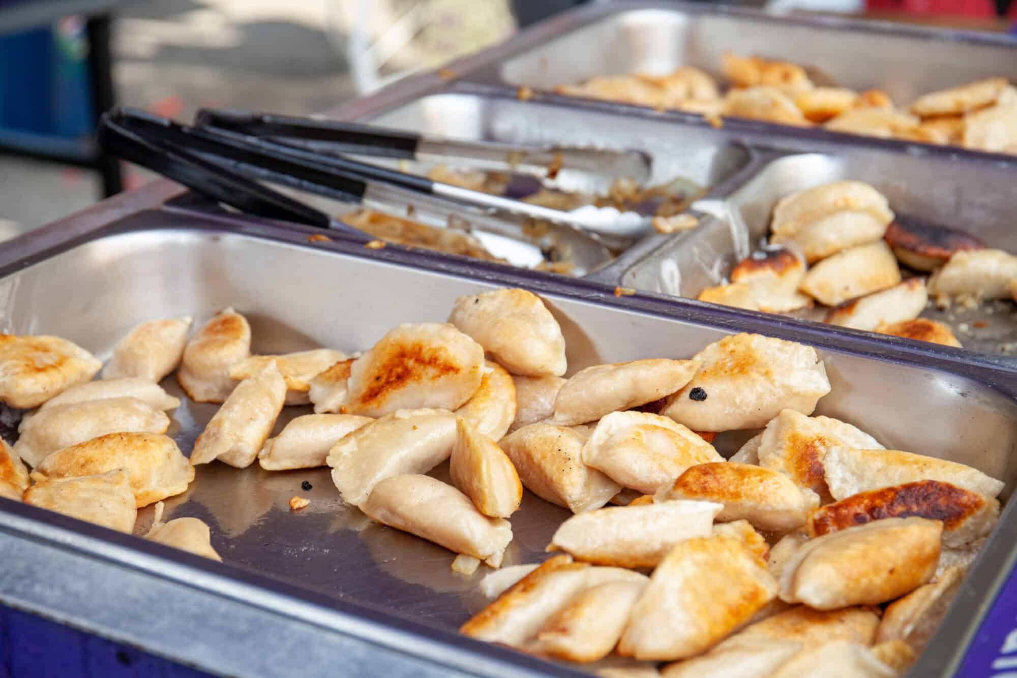 A photo of crispy pierogies in a dish.