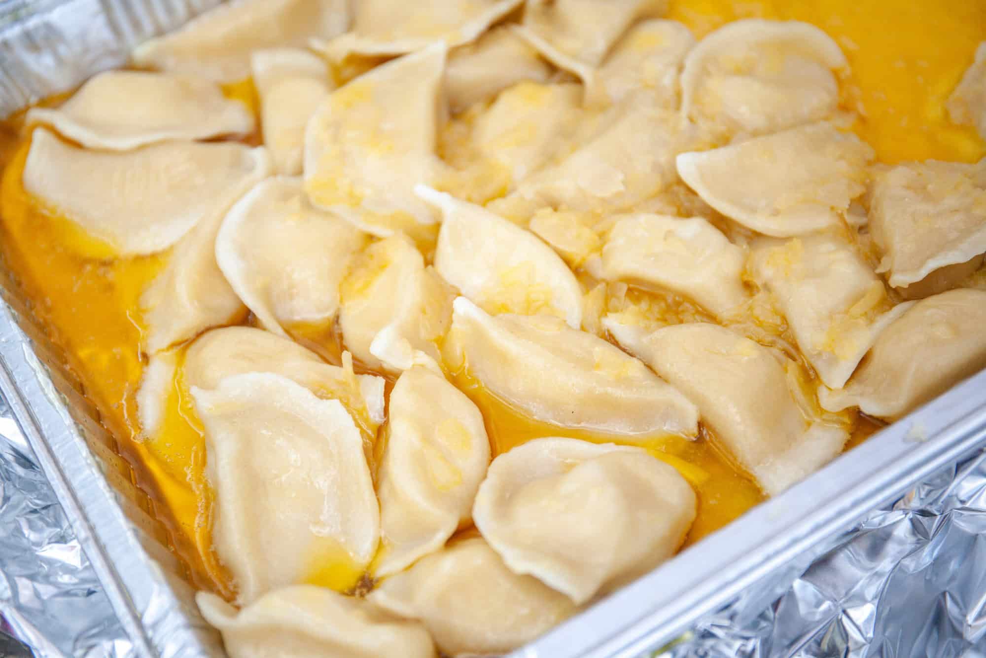 A photo of pierogies in a dish.