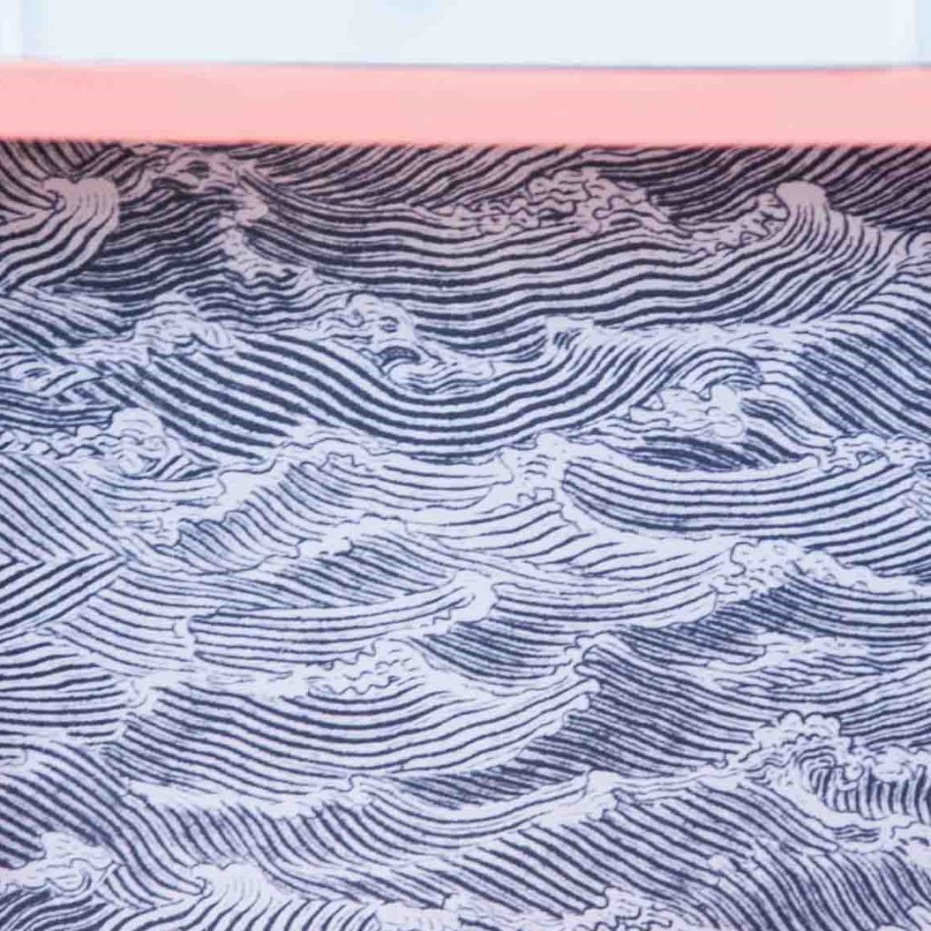 Detail of Japanese style wallpaper waves pattern glued inside the nightstand