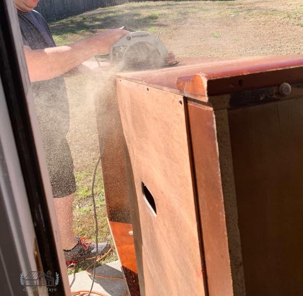 Removing the top of the repurposed television cabinet armoire 