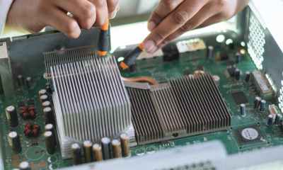 crop technician checking contacts on motherboard in workshop