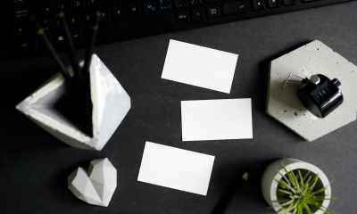 stationery keyboard and business cards lying on desk