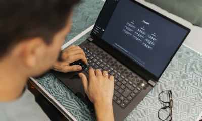 a man typing on a laptop computer