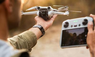 close up of man with drone and controller