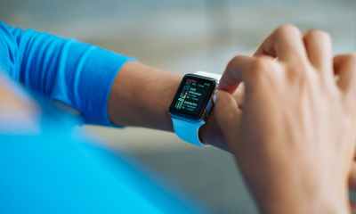 person in blue long sleeve shirt using smart watch