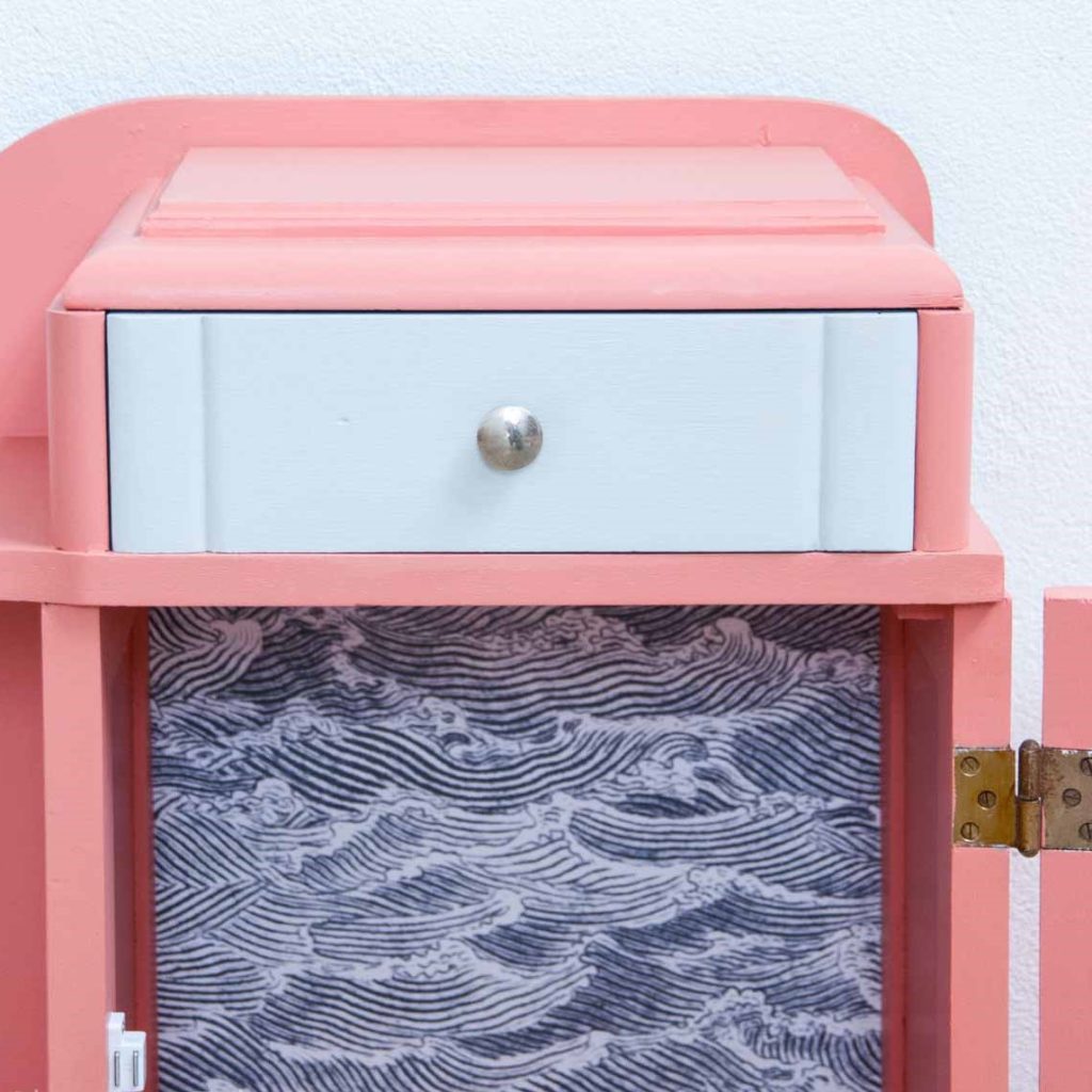 detail of blue painted drawer and Japanese style waves pattern wallpaper