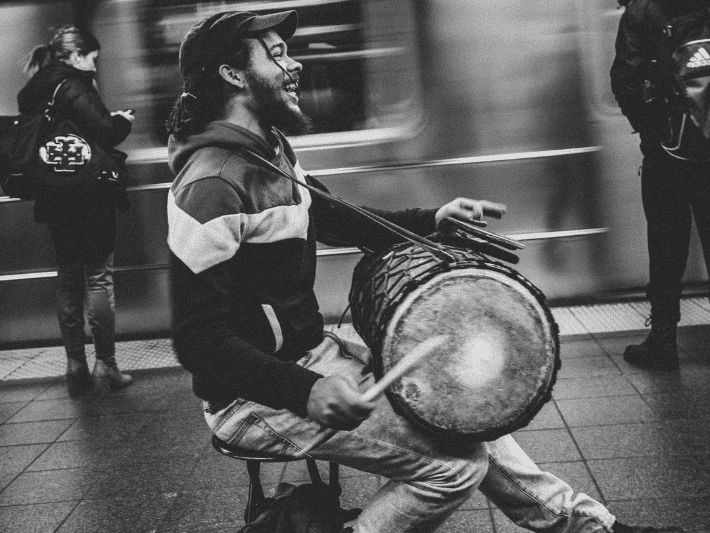 man in underground station playing drums