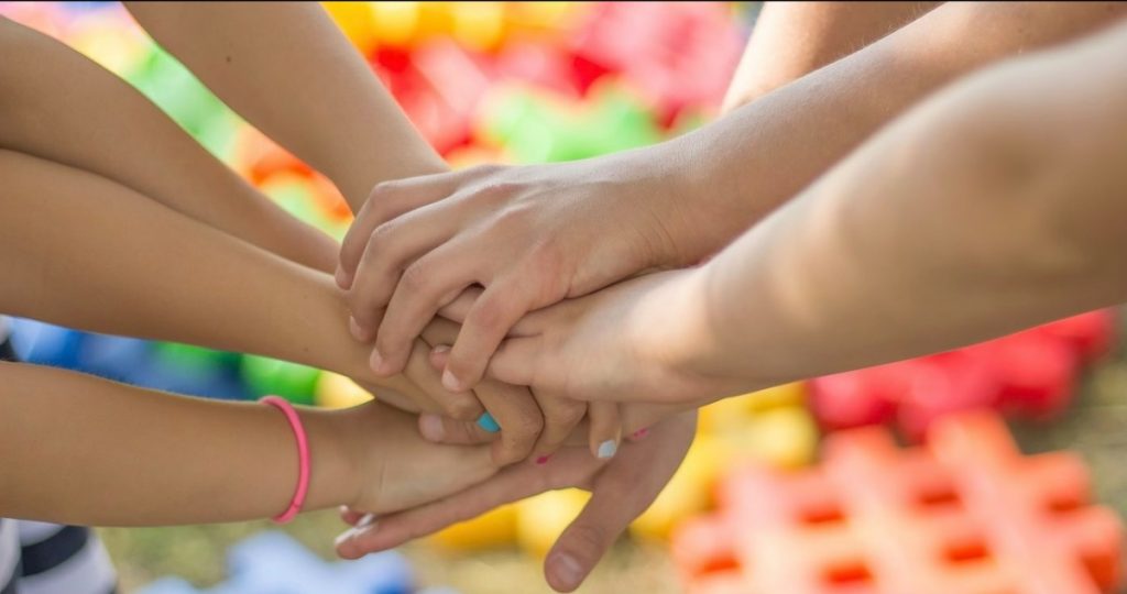 A photo of children's hands grasping.