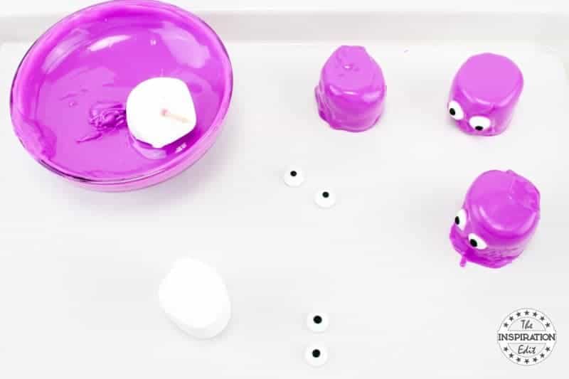 dipping marshmallows into purple melts 