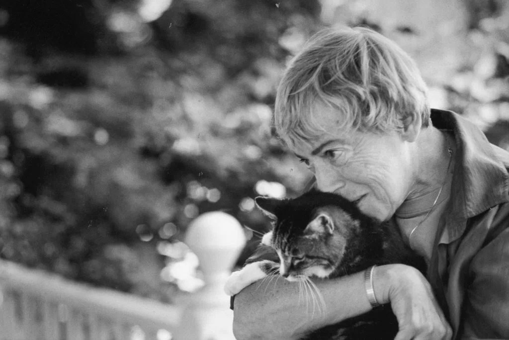 Photo of Ursula Le Guin, author of The Dispossessed, in black and white holding a cat