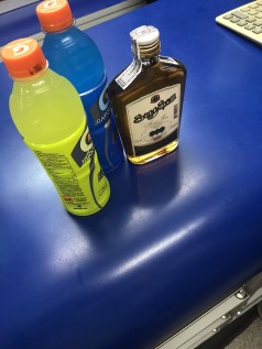 Bottle of Sangsom Rum and Gatorade on shop counter