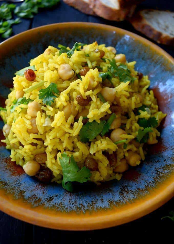 Vegan curried rice with raisins, cilantro, and chick peas.