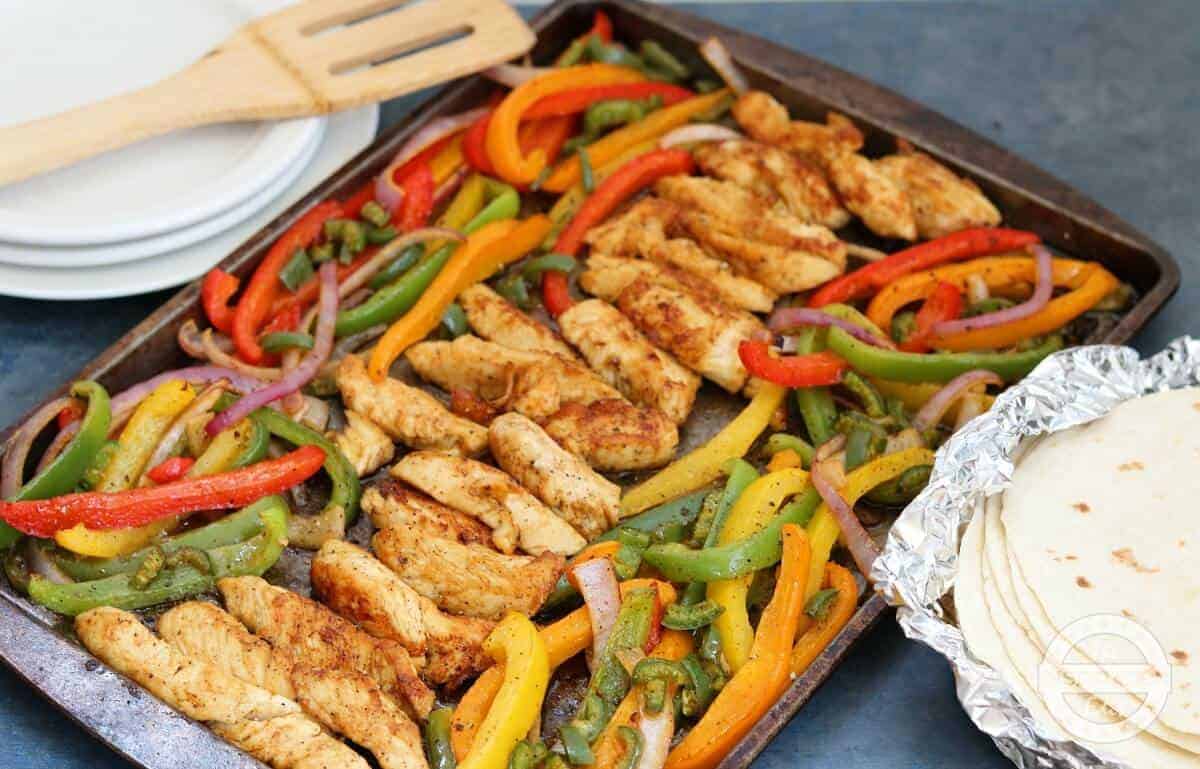 Weight Watchers healthy chicken fajitas recipe with the fajitas on a sheet pan