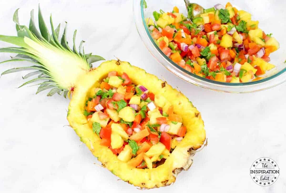 Pineapple jalapeno salsa in a bowl and in a hollowed out pineapple.