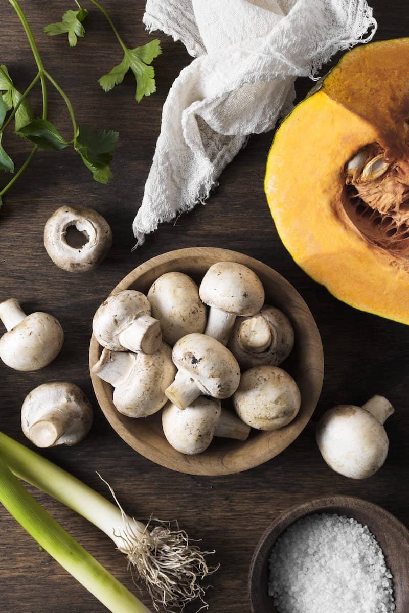 Freshest Mushroom Capsules | A collection of Mushrooms on a counter top.
