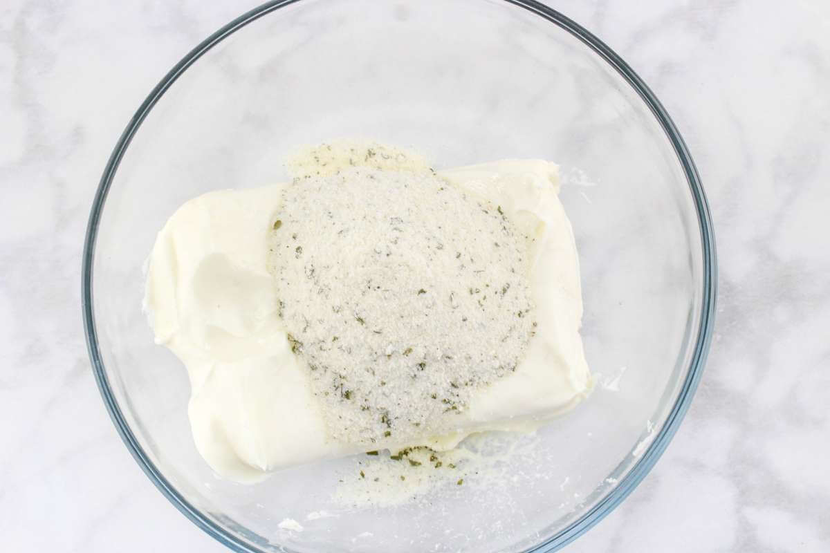 Cream cheese and ranch seasoning in a bowl.