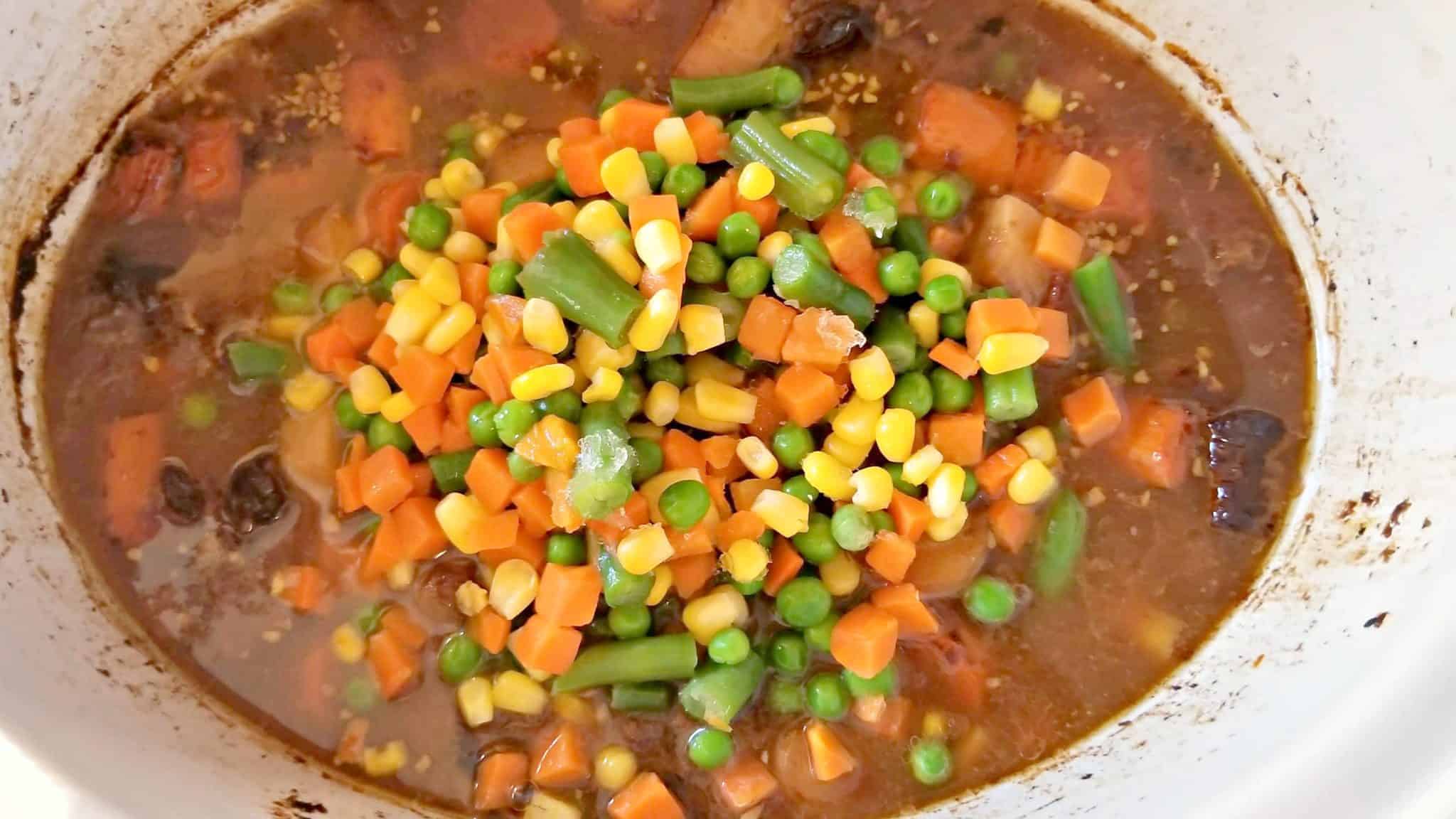 vegetables and beef in a slow cooker.