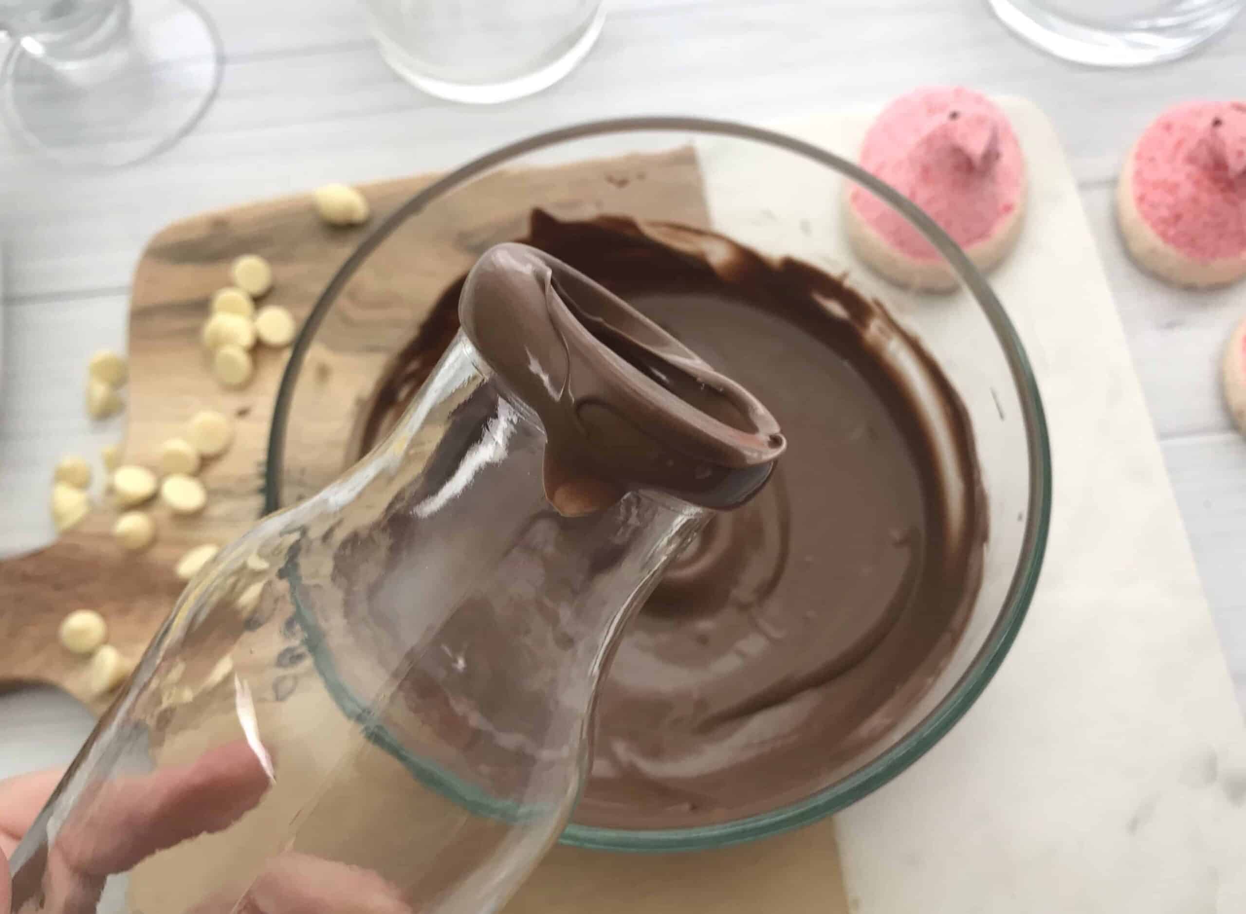 Dipping bottle tip in melted chocolate.