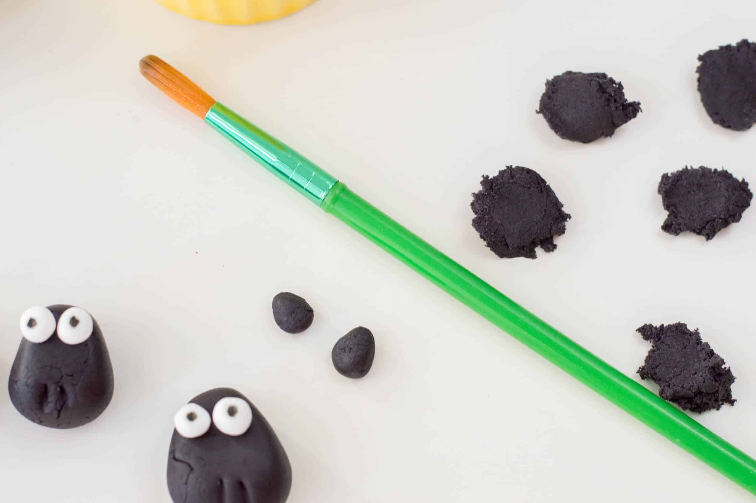 Designing sheep with black fondant.