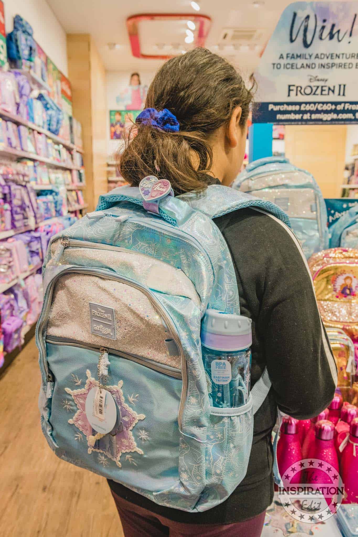 A girl wearing the smiggle bakpack.