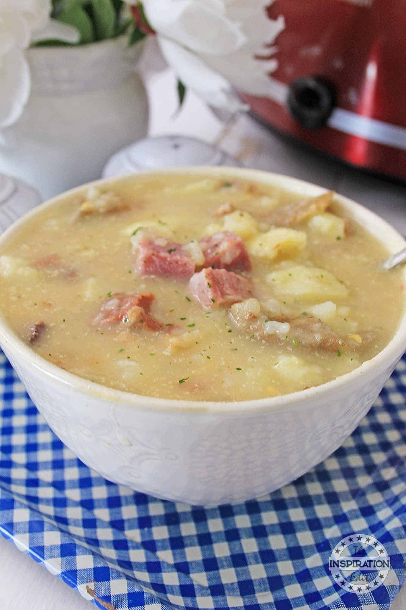 potato and ham soup in a white bowl