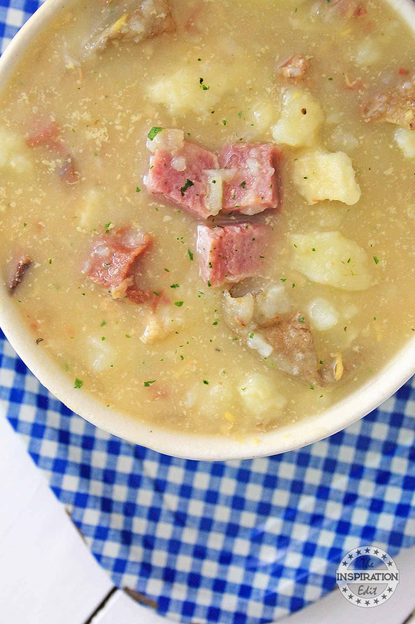 potato and ham soup in a white bowl
