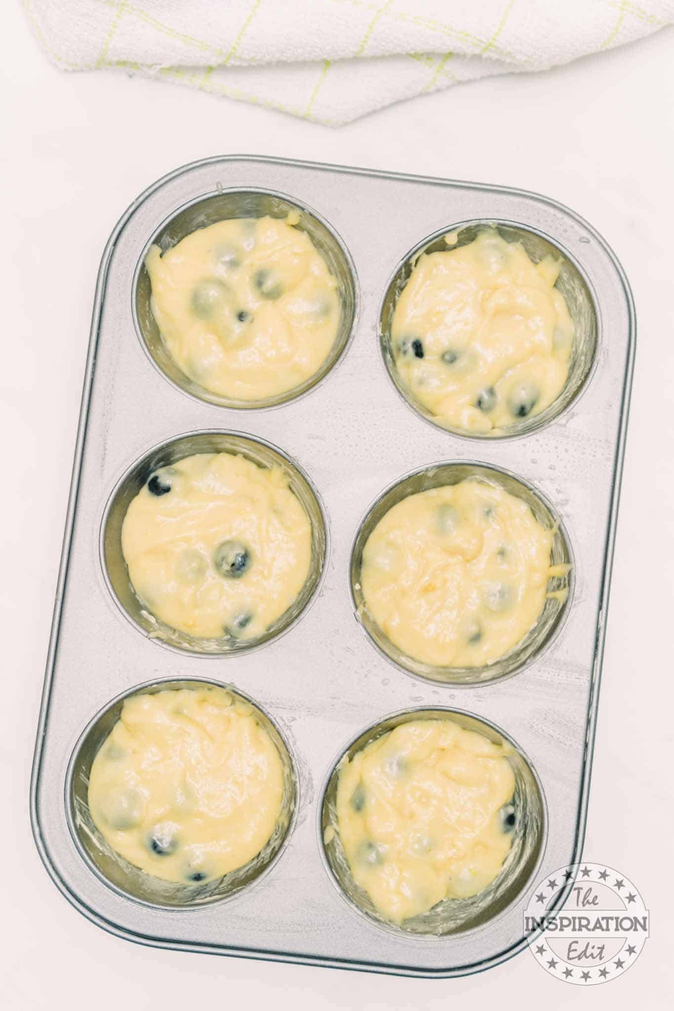 Muffins mixture in a muffin tray.