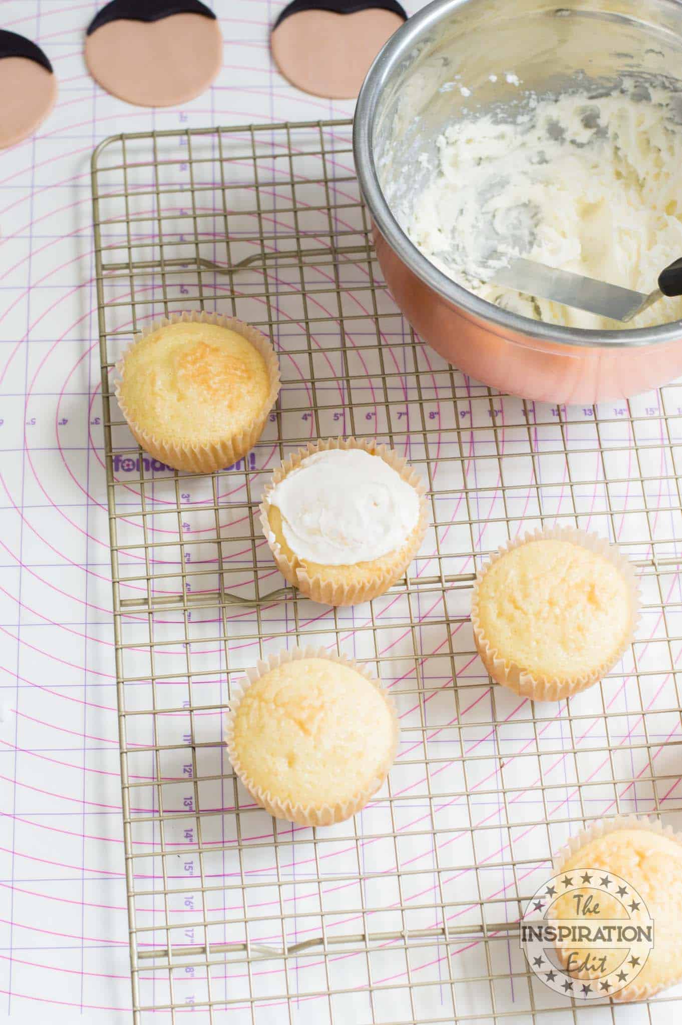 Decorating cupcakes with frosting.