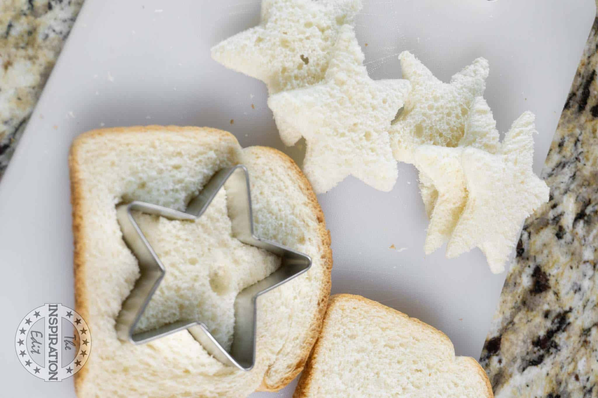 Cutting out stars from bread slices with sandwich cutter.