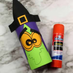 Toilet paper roll witch craft and a glue stick.