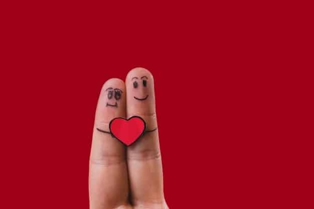 Fingers with Drawn Faces and Heart in the Middle.