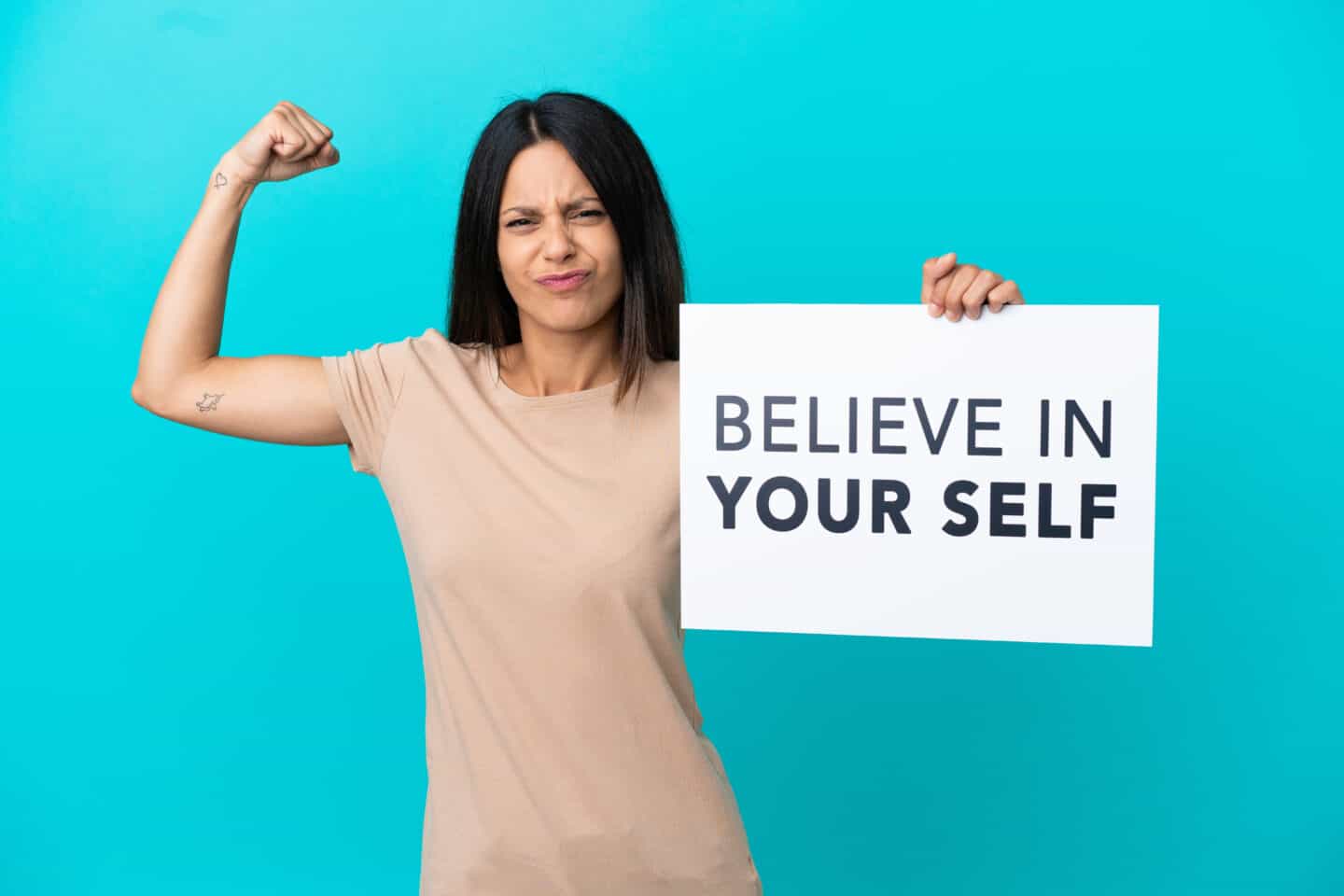 Women Holding Paper That Says Believe in Yourself.