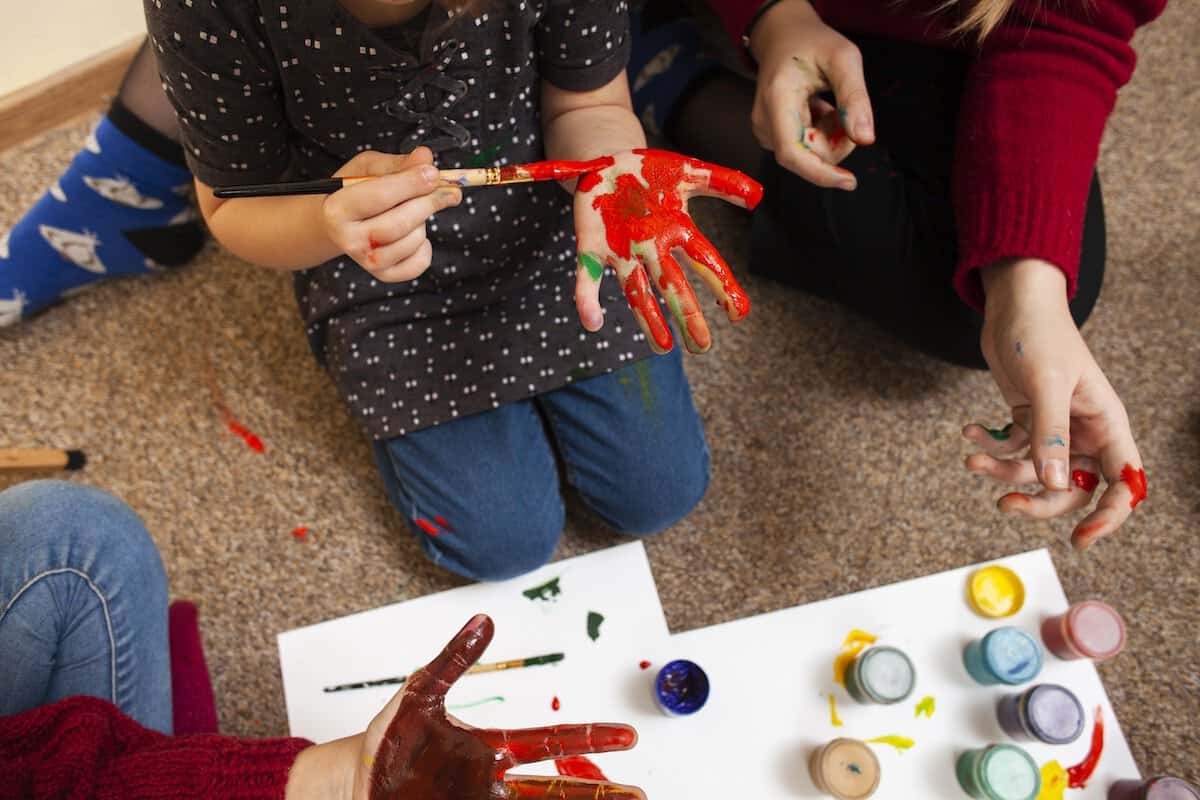 Fun Weekend Family Activities | young girl painting her hand.