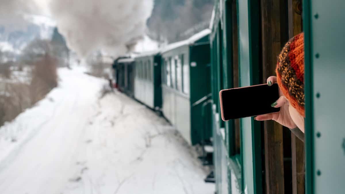 Common Travel Methods | Woman Traveling By Train and Taking a Photo on her Cell Phone.