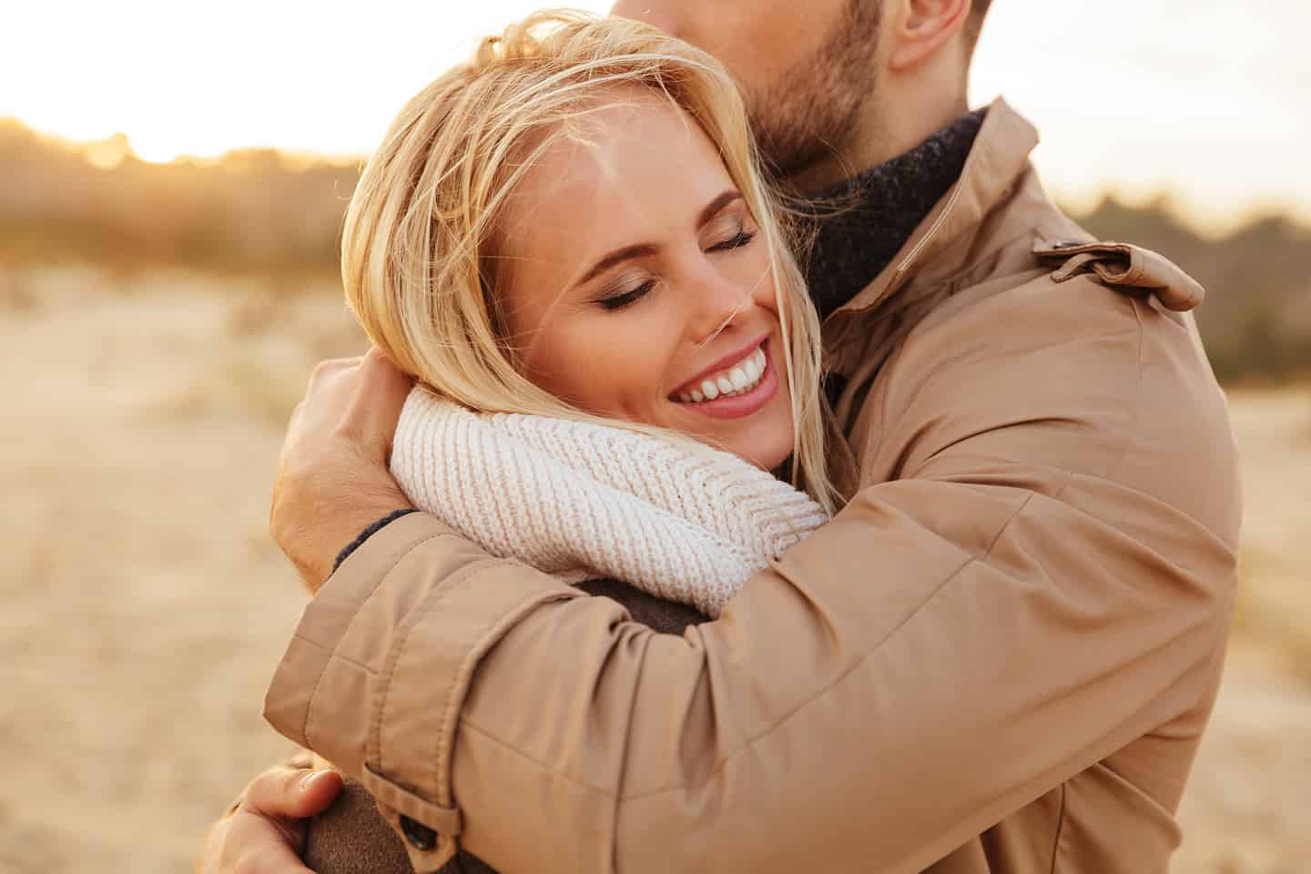 Happy Couple Hugging in a Field.