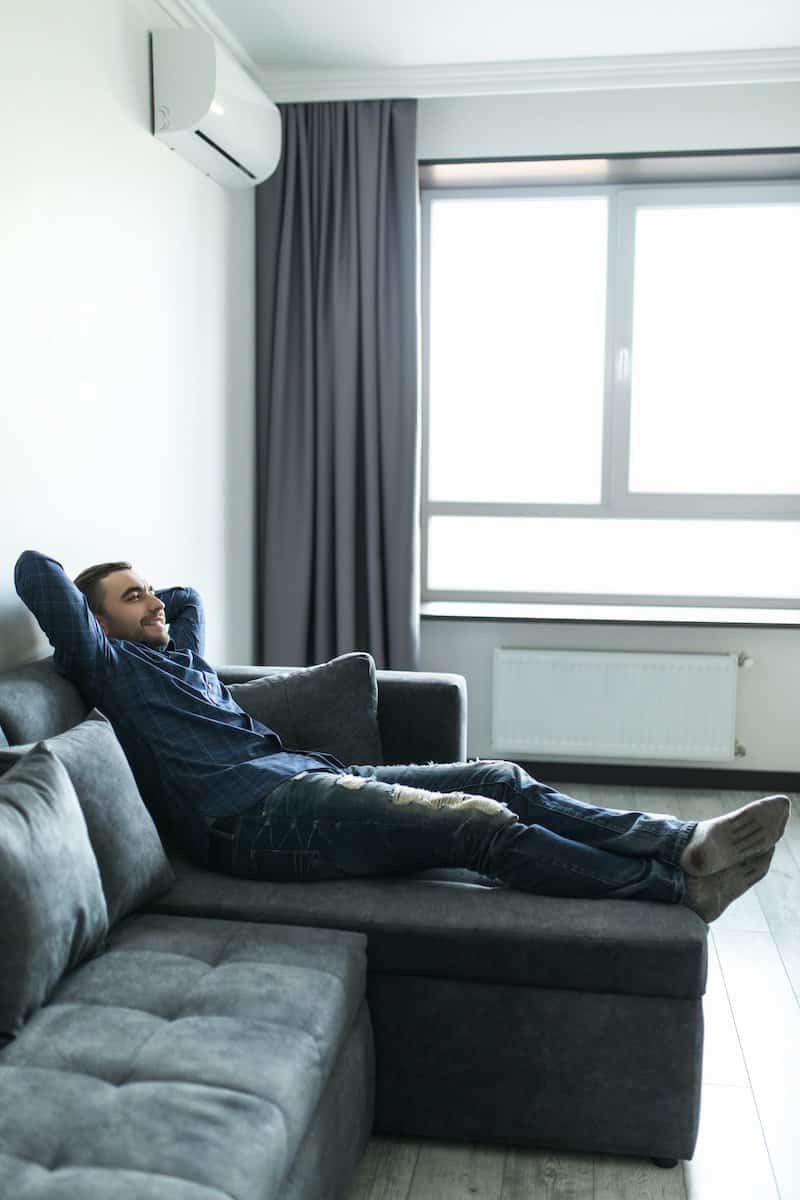 solutions for cooling your home | Man enjoying the Heat pump being on.