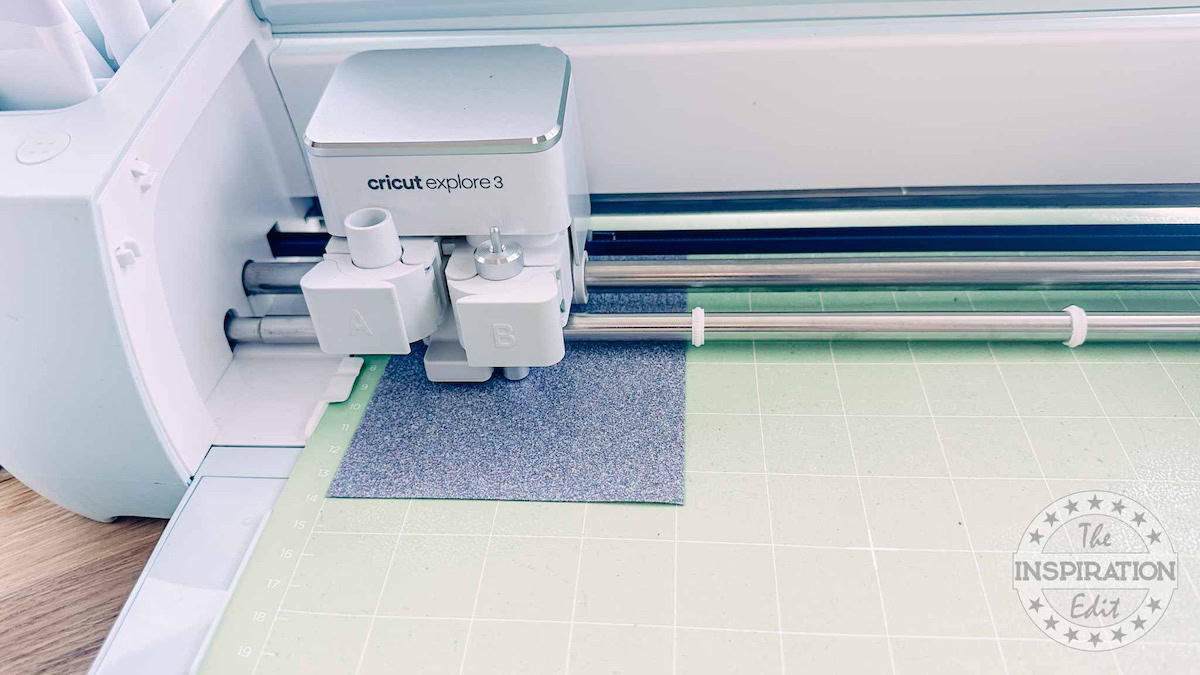Cricut EasyPress Mini Zen Blue | Cricut cutting out the transfer logo.