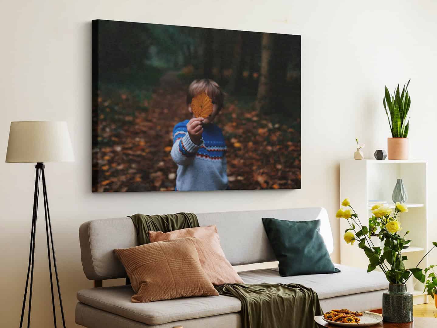 a canvas of a child playing in autumn