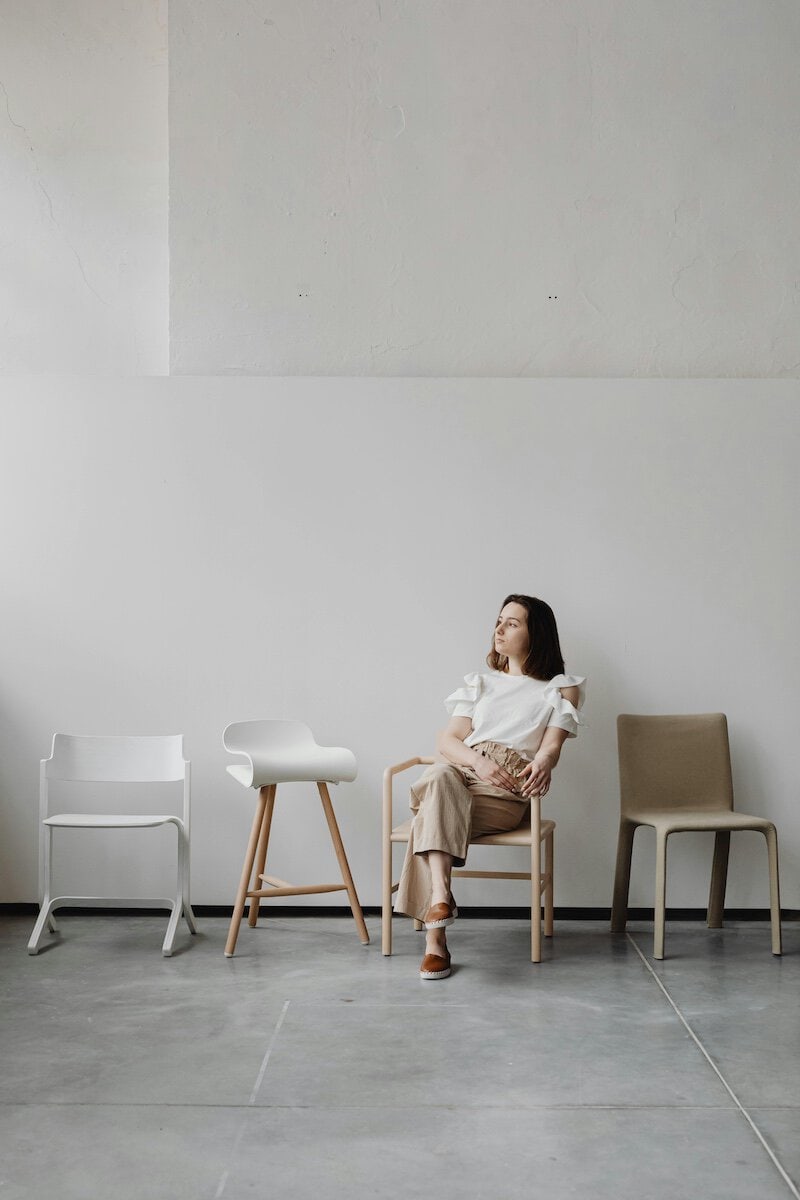 Modern Benefits Of Polished Concrete | Woman sat in a chair of a newly laid concrete floor.