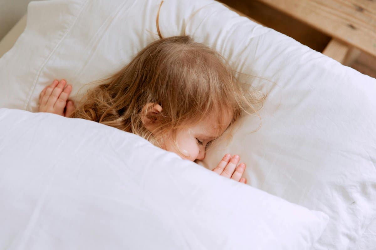 Techniques For Busy Parents | Child sleeping in a bed.