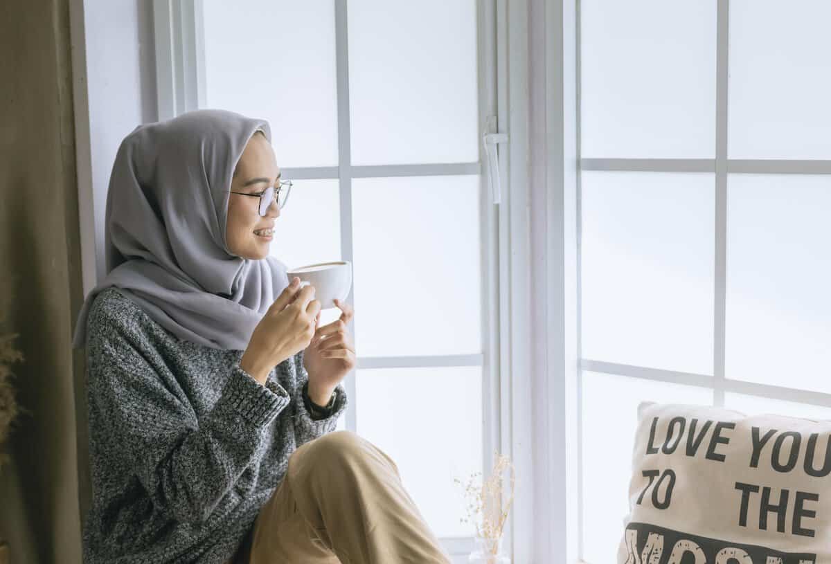 Health and Happiness Through Self-Care | Woman having some Me time with a warm drink.